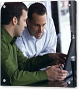 Two Young Caucasian Men Look At A Computer And Converse About Its Content Acrylic Print