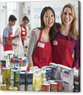 Volunteers Smiling Near Canned Goods At Food Drive Acrylic Print