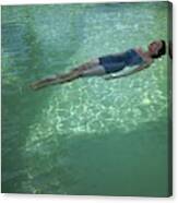 A Model Floating In A Swimming Pool Canvas Print