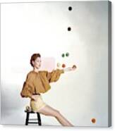 A Model Sitting On A Stool Juggling Canvas Print