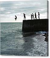 Boys Jumping Off A Pier On The Seafront Canvas Print