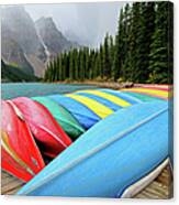 Canoes Line Dock At Moraine Lake, Banff Canvas Print