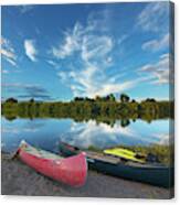 Canoes With Clouds Reflecting Canvas Print