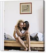 Couple Sitting On Bed Hugging Canvas Print