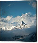 Dramatic Clouds Swirling Around Snowy Canvas Print
