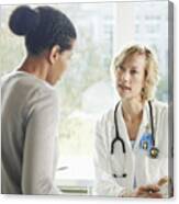 Female Doctor And Patient Talking In Exam Room Canvas Print