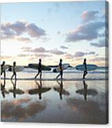 Five Surfers Walk Along Beach With Surf Canvas Print