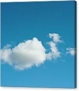 Fluffy Clouds In A Blue Sky Canvas Print