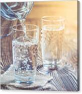 Glass Of Water On A Wooden Table Canvas Print
