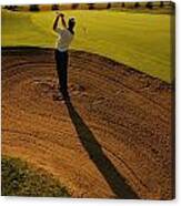 Golfer Taking A Swing From A Golf Bunker Canvas Print