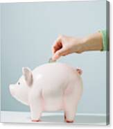 Hand Placing Coin In Piggy Bank Canvas Print