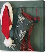 Hanging Stockings And Santa Hat On Hook Canvas Print