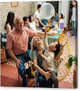 Happy Mexican Grandparents And Grandson Playing With Balloon Canvas Print