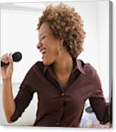 Hispanic Woman Singing On Microphone In Bedroom Canvas Print