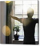 Man Opening Curtains In The Morning Canvas Print