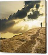 Man Walking Under Dramatic Clouds Over Grassy Rural Hill Canvas Print