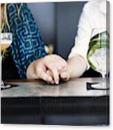 Midsection Of Lesbian Couple Holding Hands With Glasses Of Cocktail On Bar Counter Canvas Print