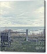 Pair Of Wooden Chairs Overlooking Ocean On A Cold Grey Afternoon Canvas Print