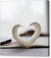 Pen And Pages Of Notebook Forming Heart-shape Canvas Print