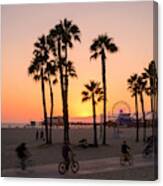 People Ride Bikes And Walk Along The Beach At Sunset In Santa Monica, California. Canvas Print