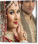 Portrait Of An Indian Bride Posing With Her Husband In Background Canvas Print