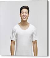Portrait Of Smiling Young Man Wearing White T-shirt Canvas Print