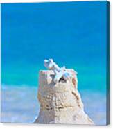 Sand Castle With Coral Against Calm Turquoise Sea Canvas Print