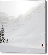 Skier Climbs Snowy Ridge Below Misty Canvas Print