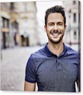 Smiling Man Standing On City Street Canvas Print