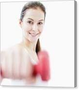 Smiling Young Woman Holding Dumbbell Canvas Print
