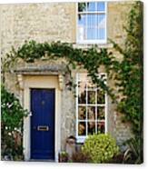 Stone Cottage With Windows And Blue Door Canvas Print