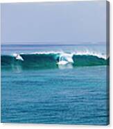 Surfers Surfing A Wave Canvas Print