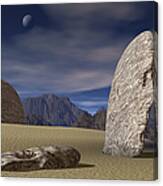 Three Stone Faces Lay Scattered Across A Desert Mountain Landscape Canvas Print