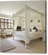 White Four-poster Bed In Large Neutral-colored Bedroom Canvas Print