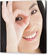 Woman Looking Through Fingers Canvas Print