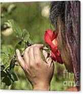 Young Asian Girl Smelling A Rose Canvas Print