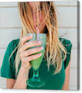 Young Blond Woman In A Green Top, Drinking Juice Canvas Print