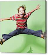 Young Boy Jumping In Mid-air Canvas Print