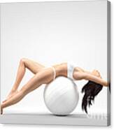 Young Slim Woman Balancing On Exercise Ball Canvas Print