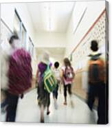 Young Students Walking Down Hallway Of School Canvas Print
