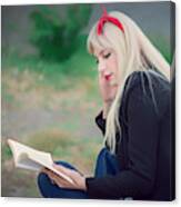 Young Woman Relaxing While Reading A Book At The Park Canvas Print