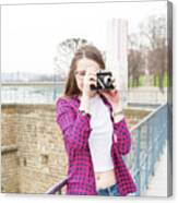 Young Woman Taking Photo With Camera Canvas Print