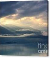 Sunlight And Clouds Over An Alpine Lake Canvas Print