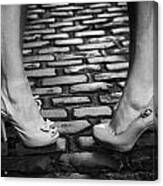 Two Young Women Wearing High Heeled Shoes And Fake Tan On Cobblestones On A Night Out Canvas Print