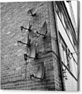 Array Of Old And New Satellite Television Receiver Dishes On The Wall Of An Apartment Block Of Flats Canvas Print