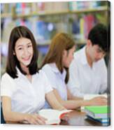 Asian Student Lady Smile And Read A Book In Library In Universit Canvas Print