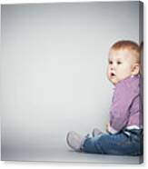 Cute Toddler Sitting On The Floor. Canvas Print