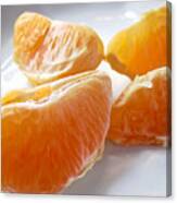 Juicy Orange Slices On A Blue Glass Plate Canvas Print