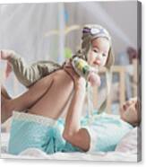 Mother Play With Her Baby After Walkup On The Bed In Bedroom Canvas Print