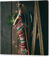 Striped Wool Stocking With Old Skis And Sparkling Lights Canvas Print